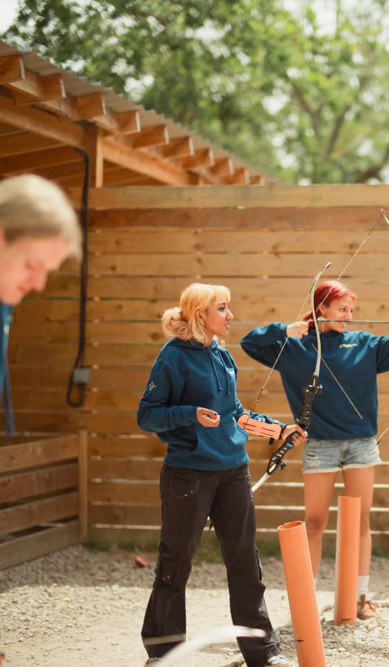 Explorers taking aim with bows at a district archery activity day